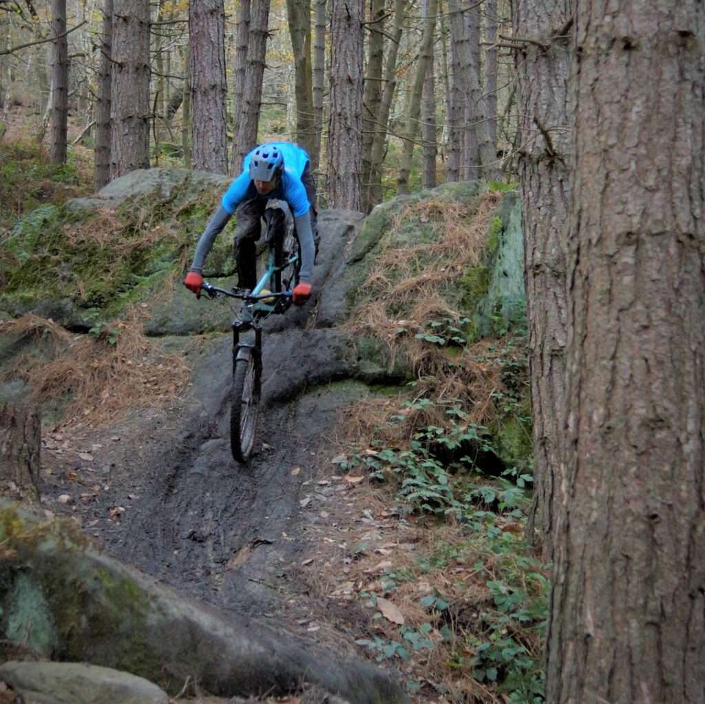 Rider in mountain bike coaching session for enduro racing, UK